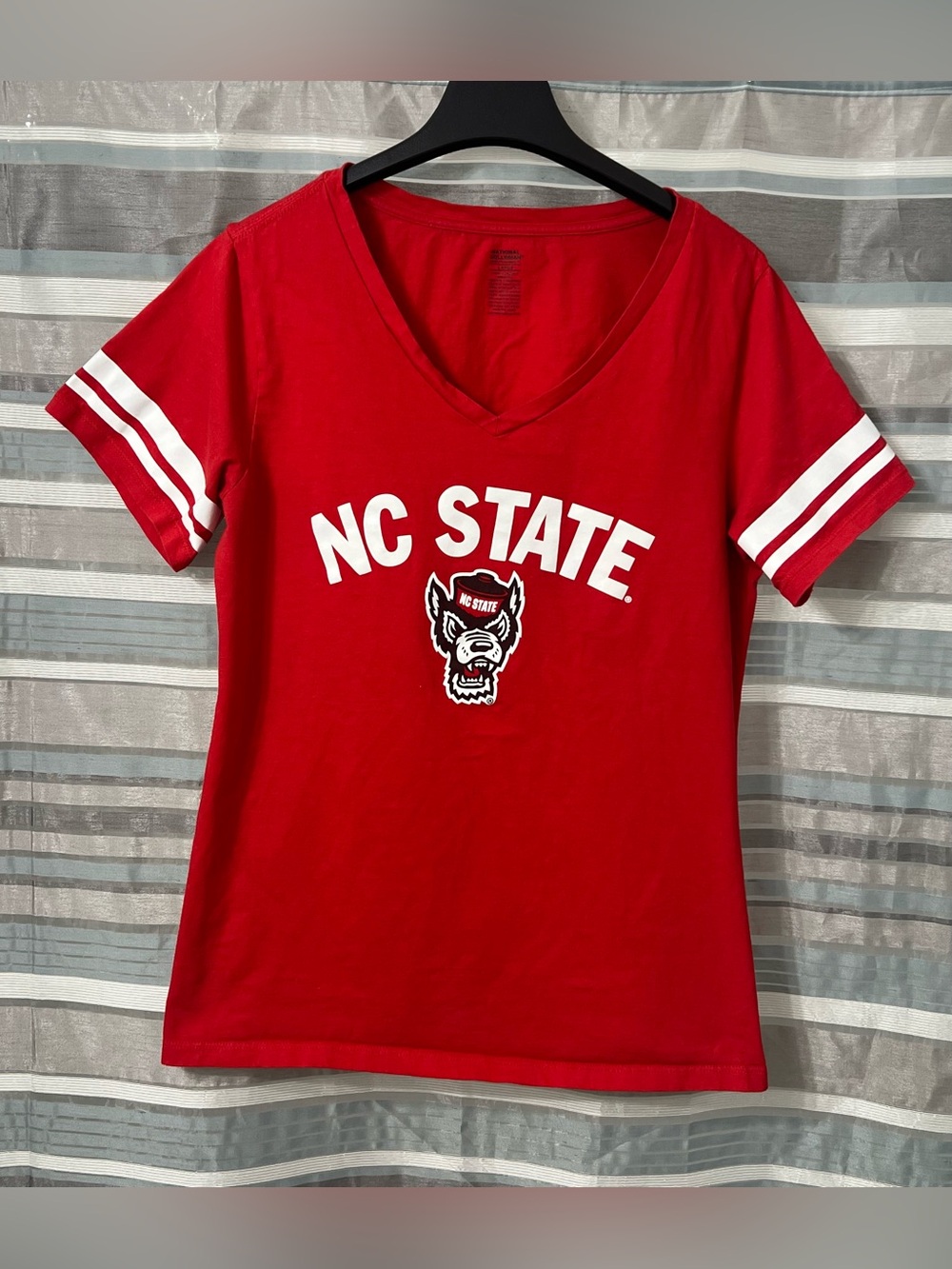 NC State Wolfpack Women’s Red V‑Neck Tee with White Sleeve Stripes
